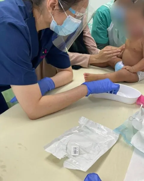 Dr Kartini applying wet wraps to a young child with eczema