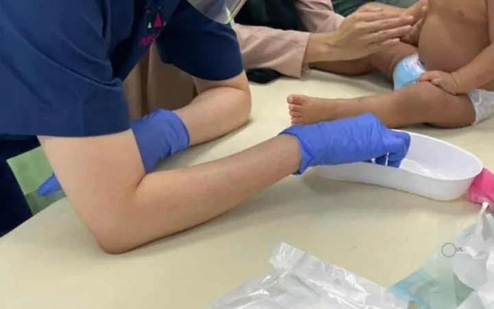 Dr Kartini applying wet wraps to a young child with eczema