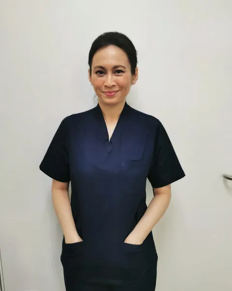 Dr Kartini Farah Rahim in clinic scrubs